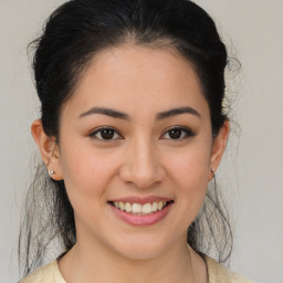 Joyful latino young-adult female with medium  brown hair and brown eyes