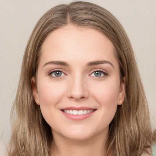 Joyful white young-adult female with long  brown hair and grey eyes