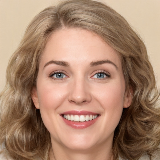 Joyful white young-adult female with long  brown hair and green eyes