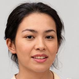 Joyful asian young-adult female with medium  brown hair and brown eyes