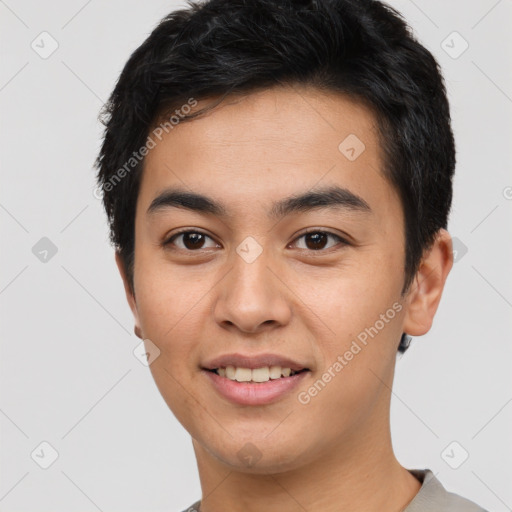 Joyful asian young-adult male with short  black hair and brown eyes