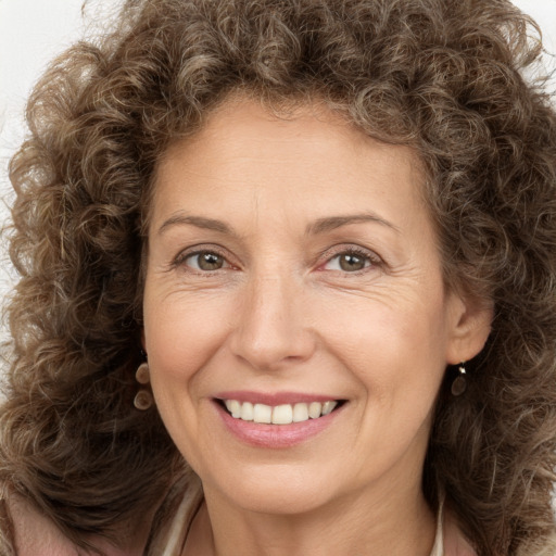 Joyful white adult female with long  brown hair and brown eyes