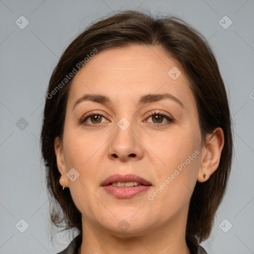 Joyful white adult female with medium  brown hair and brown eyes