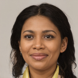 Joyful black adult female with medium  brown hair and brown eyes