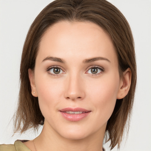 Joyful white young-adult female with medium  brown hair and green eyes