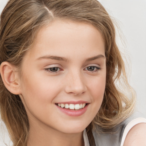 Joyful white child female with long  brown hair and brown eyes