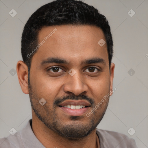 Joyful black young-adult male with short  black hair and brown eyes