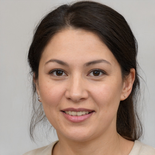 Joyful white young-adult female with medium  brown hair and brown eyes