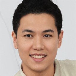 Joyful asian young-adult male with short  black hair and brown eyes