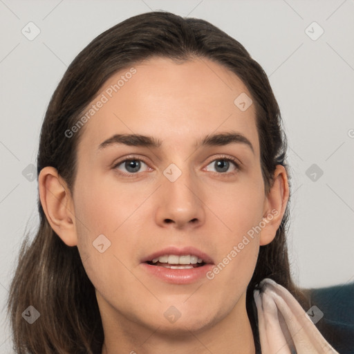 Joyful white young-adult female with long  brown hair and brown eyes