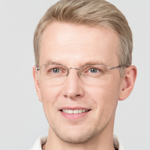 Joyful white adult male with short  brown hair and grey eyes