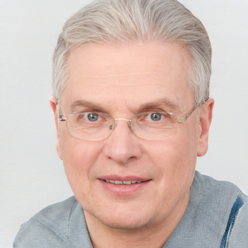 Joyful white middle-aged male with short  gray hair and blue eyes