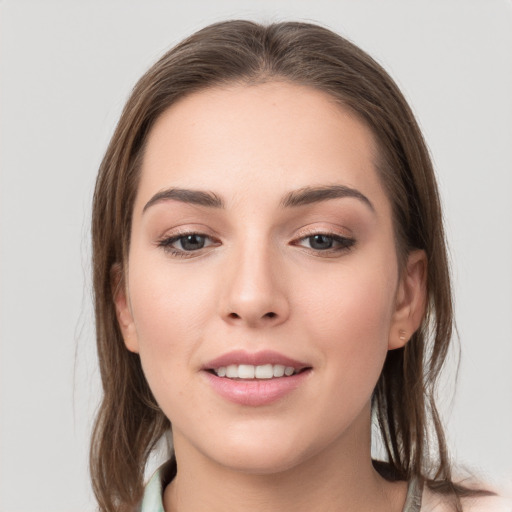 Joyful white young-adult female with medium  brown hair and grey eyes