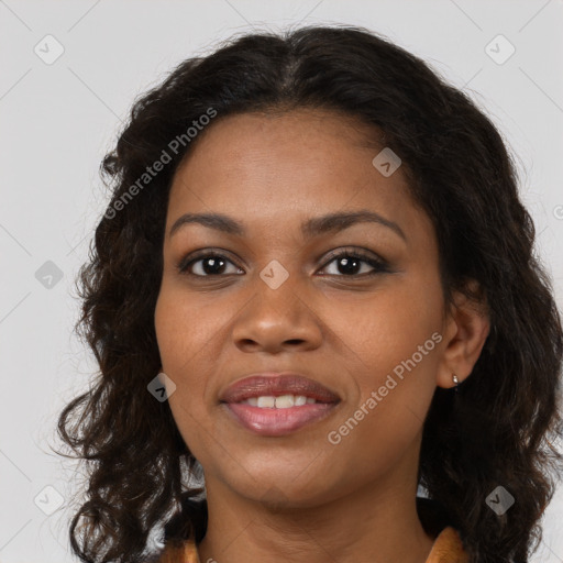 Joyful black young-adult female with long  brown hair and brown eyes