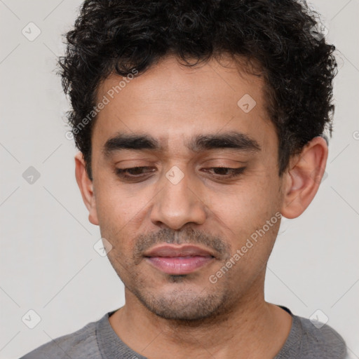 Joyful latino young-adult male with short  brown hair and brown eyes