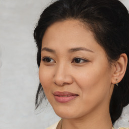 Joyful asian young-adult female with medium  brown hair and brown eyes