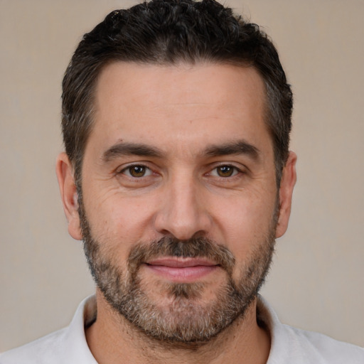 Joyful white adult male with short  brown hair and brown eyes