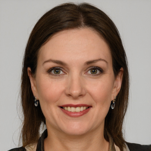 Joyful white adult female with long  brown hair and grey eyes