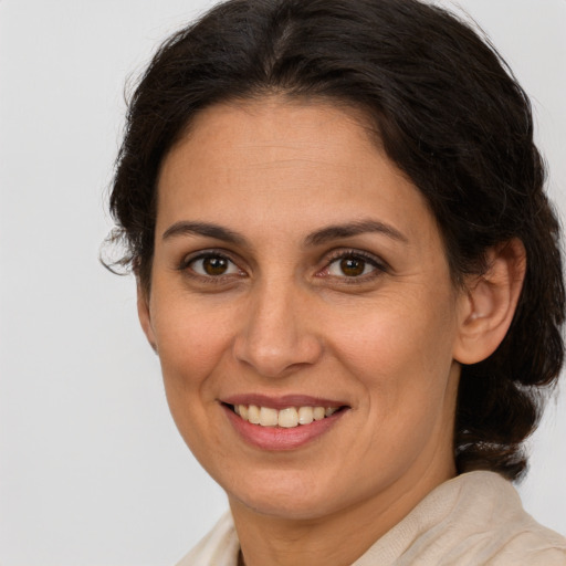 Joyful white adult female with medium  brown hair and brown eyes