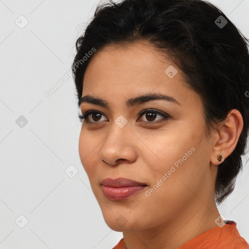 Joyful latino young-adult female with medium  brown hair and brown eyes