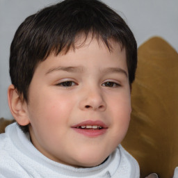 Joyful white child male with short  brown hair and brown eyes