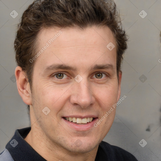 Joyful white adult male with short  brown hair and grey eyes