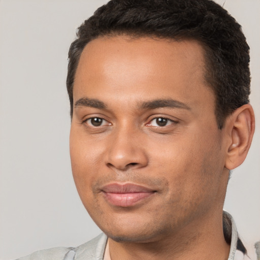 Joyful white young-adult male with short  black hair and brown eyes