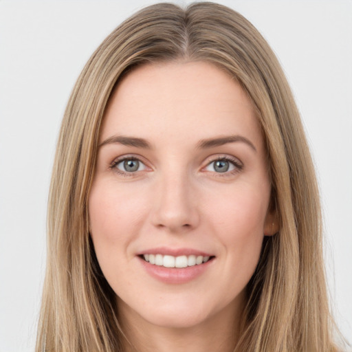 Joyful white young-adult female with long  brown hair and green eyes