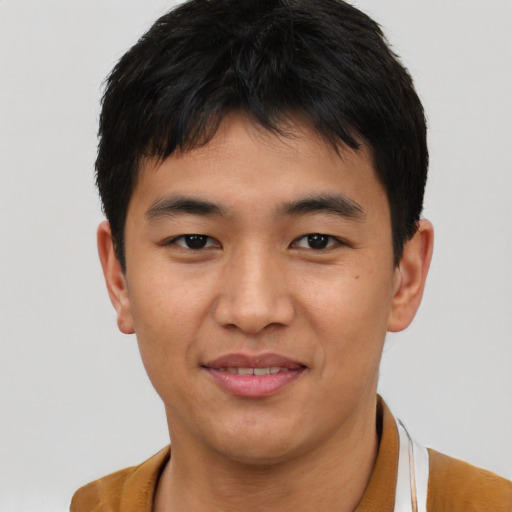 Joyful asian young-adult male with short  brown hair and brown eyes