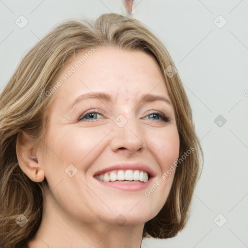 Joyful white adult female with long  brown hair and green eyes