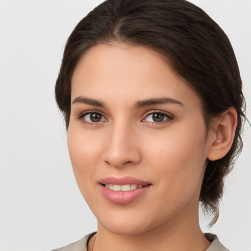 Joyful white young-adult female with medium  brown hair and brown eyes