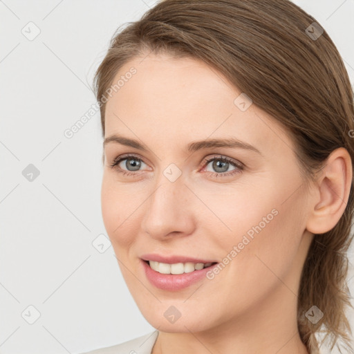 Joyful white young-adult female with medium  brown hair and grey eyes