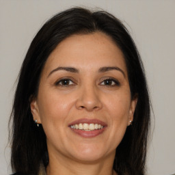 Joyful white adult female with long  brown hair and brown eyes