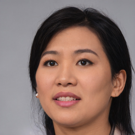 Joyful asian young-adult female with long  black hair and brown eyes
