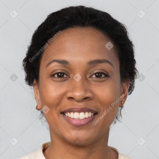 Joyful black young-adult female with short  brown hair and brown eyes