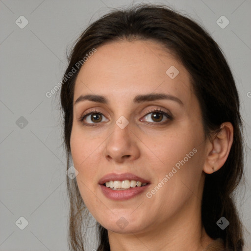 Joyful white young-adult female with long  brown hair and brown eyes