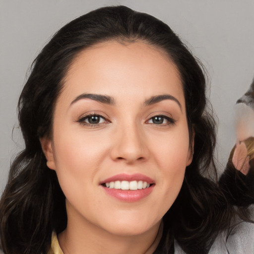 Joyful white young-adult female with long  black hair and brown eyes