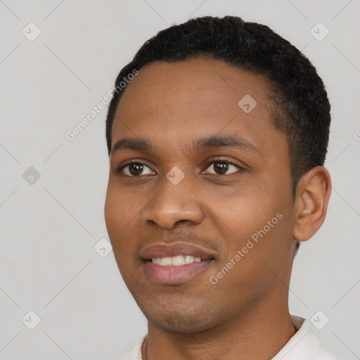 Joyful black young-adult male with short  black hair and brown eyes