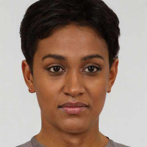 Joyful latino young-adult female with short  brown hair and brown eyes