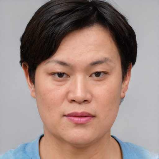 Joyful asian adult female with short  brown hair and brown eyes