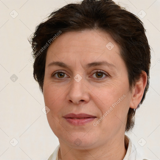 Joyful white adult female with short  brown hair and brown eyes