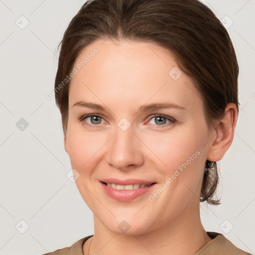 Joyful white young-adult female with medium  brown hair and grey eyes