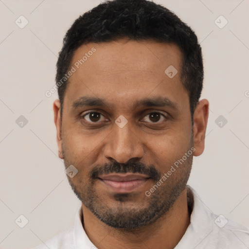 Joyful black young-adult male with short  black hair and brown eyes
