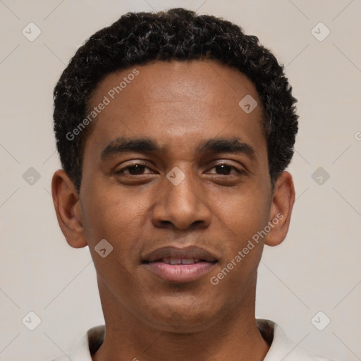 Joyful black young-adult male with short  black hair and brown eyes