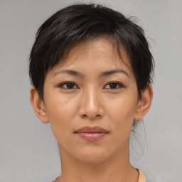 Joyful asian young-adult female with short  brown hair and brown eyes