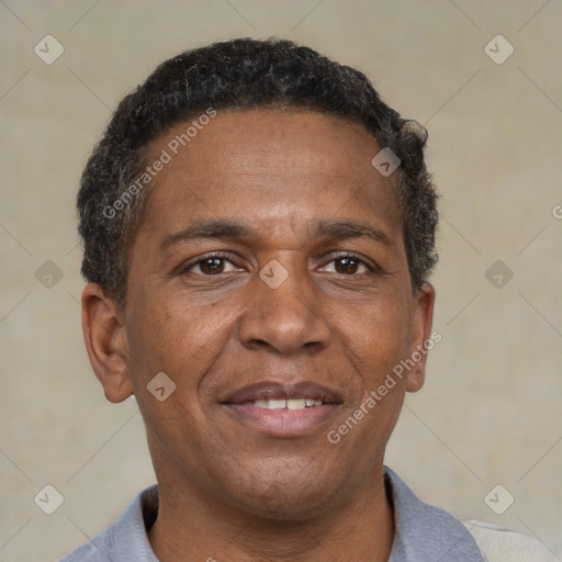 Joyful black adult male with short  brown hair and brown eyes