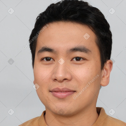 Joyful asian young-adult male with short  black hair and brown eyes