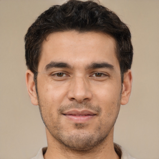 Joyful white young-adult male with short  brown hair and brown eyes