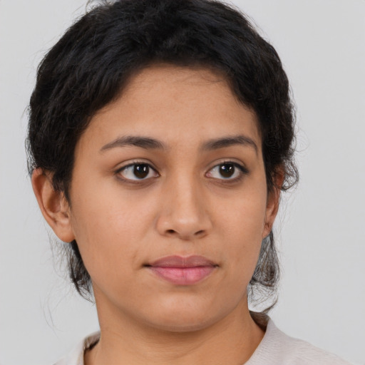 Joyful latino young-adult female with short  brown hair and brown eyes
