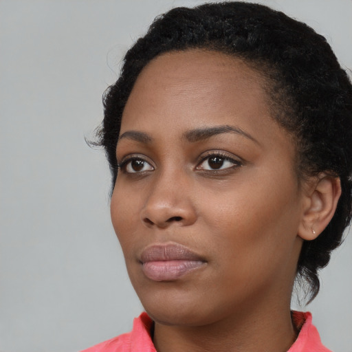 Neutral black young-adult female with short  black hair and brown eyes